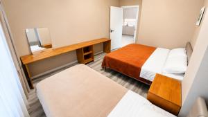 a small room with two beds and a mirror at Stylish Cozy Apartment in UB in Ulaanbaatar