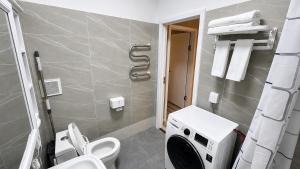 a bathroom with a toilet and a sink at Stylish Cozy Apartment in UB in Ulaanbaatar +18 photos