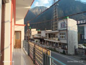 a balcony of a building with a view of a mountain at Kunjapuri Homestay in Uttarkāshi