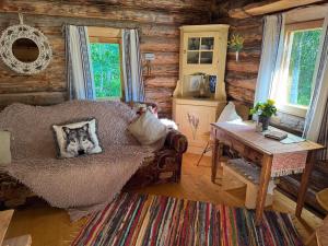 a living room with a wolf pillow on a couch at Salatse metsaonn in Salatse +26 photos