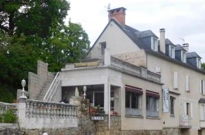 an old white house with a staircase in front of it at Chambres du Causse in Saint-Cernin-de-Larche
