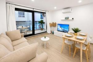 a living room with a couch and a table at Arguineguin Sun Beach in Arguineguín