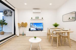 a living room with a dining table and a tv at Arguineguin Sun Beach in Arguineguín