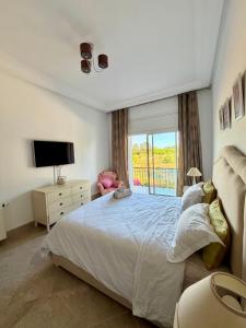 a bedroom with a large bed and a window at Comfy 2Bdrs Marsa in Carthage
