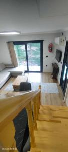 a living room with a couch and a table at LEYLİ GABAN VİLLA in Çaykara