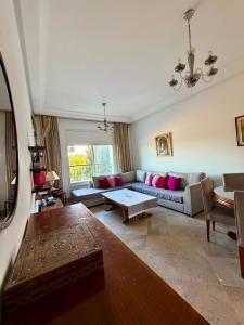 a living room with a couch and a table at Comfy 2Bdrs Marsa in Carthage