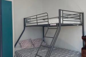 a bunk bed with two bunk beds in a room at Chambres du Causse in Saint-Cernin-de-Larche