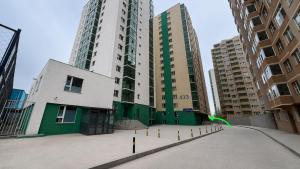 a large building in a city with tall buildings at Stylish Cozy Apartment in UB in Ulaanbaatar