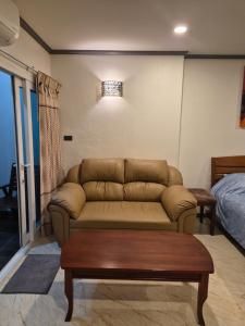 a living room with a couch and a coffee table at New world condo1104 in Ban Chak Phai +18 photos