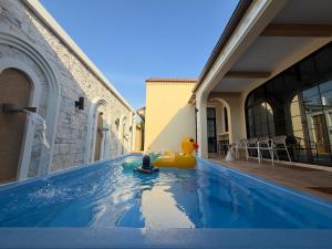 a pool with a rubber duck on the side of a building at The Verona pool villa Hatyai in Ban Khlong Pleo