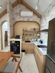 a large kitchen with a stone wall at The Verona pool villa Hatyai in Ban Khlong Pleo