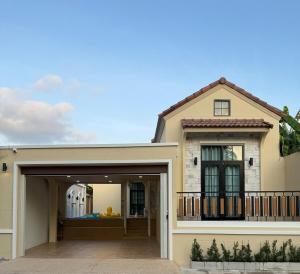 a house with a garage in front of it at The Verona pool villa Hatyai in Ban Khlong Pleo