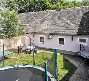 a house with a backyard with a ping pong table at Levander Apartmenthouses in Makó