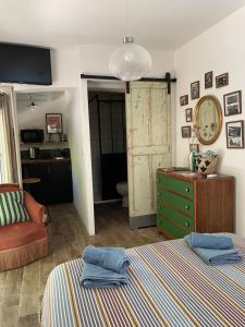 a bedroom with a bed and a green dresser at Maison d hôtes LA VILLA MADELEINE in Sanary-sur-Mer +35 photos