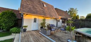 a house with a deck with plants and a swimming pool at La maisonnette in Forêt-la-Folie