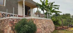 a house on top of a stone wall at Mirembe house in Mukono