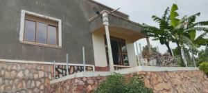 a house with graffiti on the side of it at Mirembe house in Mukono