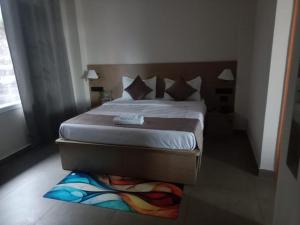 a bedroom with a large bed with a wooden headboard at The Vista Retreat in Shimla +5 photos
