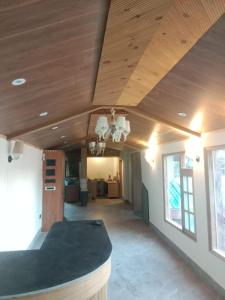a living room with a wooden ceiling and a table at The Vista Retreat in Shimla