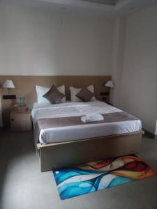a bedroom with a large bed with a colorful rug at The Vista Retreat in Shimla