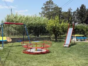 a playground with a picnic table and a slide at Agriturismo Bufaleria in Scanzano