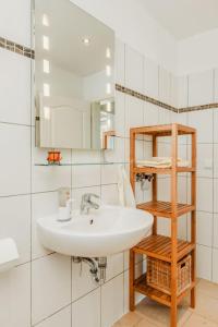 a bathroom with a sink and a mirror at Haus Teltow in Teltow +41 photos