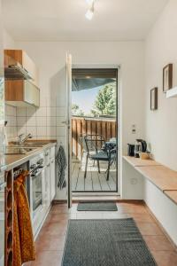 a kitchen with a sliding door leading to a deck at Haus Teltow in Teltow