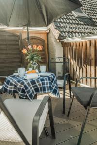a table and chairs on a patio with an umbrella at Haus Teltow in Teltow