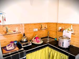a kitchen with a sink and a counter top at Green Mountain Cabin in Nuwara Eliya