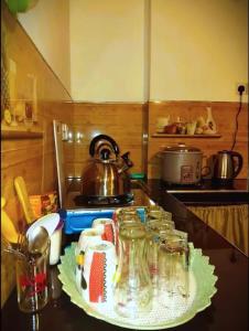 a kitchen counter with several glass jars on a table at Green Mountain Cabin in Nuwara Eliya +17 photos