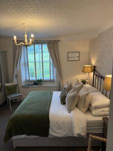 a bedroom with a large bed and a window at Bewerley Hall farm in Harrogate