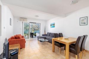 a living room with a couch and a table at Kotor Muo F1 in Muo