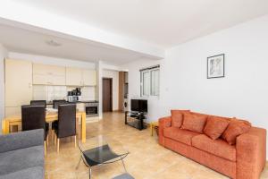 a living room with a couch and a table at Kotor Muo F1 in Muo +7 photos