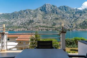 a balcony with a table and a view of a mountain at Kotor Muo F1 in Muo