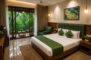 a bedroom with a bed and a chair and a window at Athirapilly Fernvalley Resort in Athirappilly +122 photos