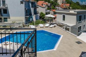 a balcony view of a swimming pool on a building at Kotor Muo F1 in Muo