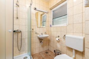 a bathroom with a shower and a toilet and a sink at Kotor Muo F1 in Muo