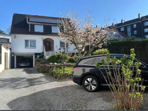 a car parked in the driveway of a house at Pension Hoffmann Remscheid in Remscheid