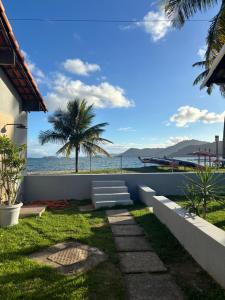 a patio with a view of the ocean at Espaço Praia - Studio 109 in Angra dos Reis