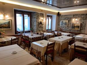 a dining room with tables and chairs in a restaurant at Hotel del Corso in Sestola
