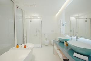 a bathroom with two sinks and two toilets at Palazzo M Capri in Capri +78 photos