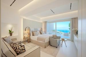 a bedroom with a bed and a living room at Palazzo M Capri in Capri