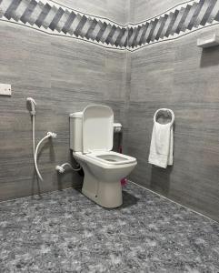 a bathroom with a toilet and a shower at Grand Bay Hotel in Arugam Bay +12 photos