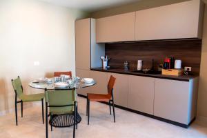 a kitchen with a table and chairs in a room at Villa Angheli in Giardini Naxos