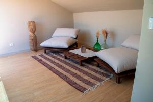 a living room with two beds and a coffee table at Villa Angheli in Giardini Naxos +12 photos