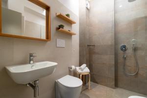 a bathroom with a sink toilet and a shower at Hotel La Pergola Dependance in Lignano Sabbiadoro