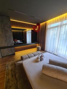 a living room with a large couch and a large window at MOCCA Lux Suite in Bitola