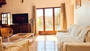 a living room with a couch and a table at Maison Aqua Bella - Terrasse - BBQ - 8pers in Contes