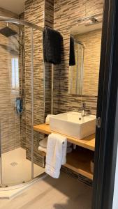 a bathroom with a sink and a shower at Canelas 22 in Sanxenxo +227 photos