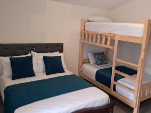 a room with two bunk beds and a ladder at Roxel Home in Baños